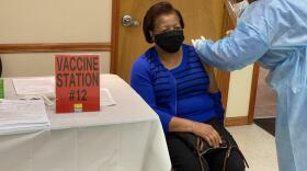 A COVID-19 vaccination is pictured being administered at St. John's Progressive Missionary Baptist Church.