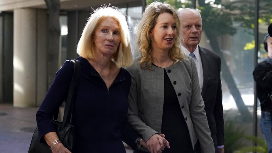 Former Theranos CEO Elizabeth Holmes, center, her mother, Noel Holmes, left, and father, Christian Holmes IV, arrive Sept. 1 at federal court in San Jose, Calif.