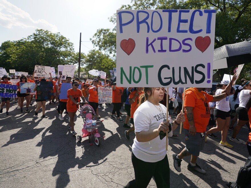 FILE - Family and friends of those killed and injured in the school shootings at Robb Elementary take part in a protest march and rally, Sunday, July 10, 2022, in Uvalde, Texas.