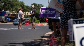 A poll watcher IS allowed to watch to make sure people aren't campaigning too close to a voting site. 