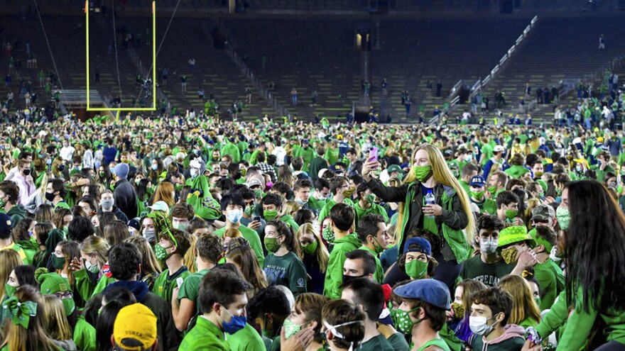 Fans storm the field after Notre Dame defeated the Clemson 47-40 in two overtimes in an NCAA college football game Saturday, Nov. 7, 2020, in South Bend, Ind.