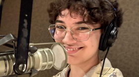 Evelyn Huspen stands next to a microphone