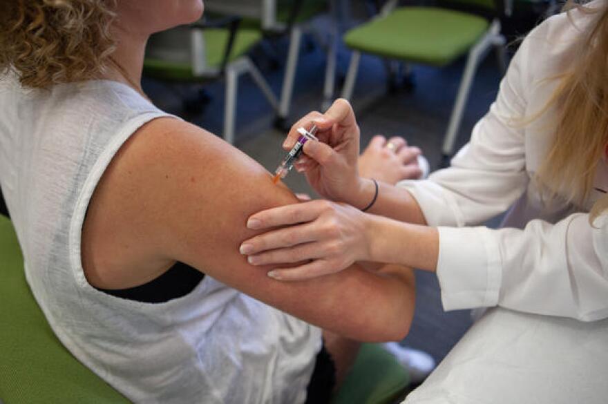 A woman gets a flu shot