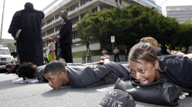 Gidget Bell (right), of Charlotte, joins other protesters in shutting down Fourth Street after a mistrial was declared in Charlotte-Mecklenburg police officer Randall Kerrick's trial.