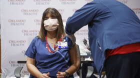 Elizabeth Rosado, RN, a 30-year veteran in the Trauma ICU unit was the first person to receive the vaccination with Orlando Health. Photo: Orlando Health
