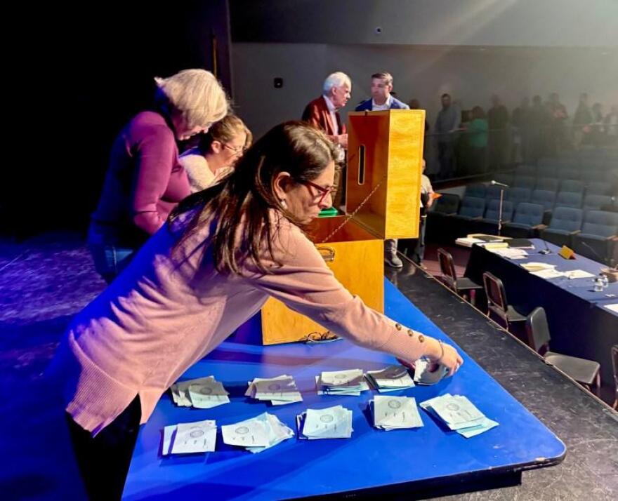 Bow Town Clerk Mridula Naik and others count the votes cast by secret ballot at the 2026 town meeting.