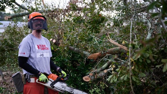 A volunteer with Team Rubicon assists with disaster cleanup efforts.