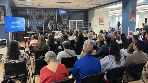 Dr. Abel Antonio Chávez, President of Our Lady of the Lake University, welcomes the group of residents, activists, and civil rights group members to the People's Hearing on Immigration Enforcement at the college's Sueltenfuss Library. 8/4/2026.
