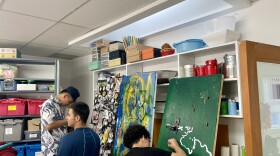 Students work on decorating three doors for the “Home/Un Hogar” exhibition at The Art Base in Basalt on Nov. 30, 2023. They chose three colors to reflect their feelings about adjusting to a new country: Black for fear, green for distance and blue for loneliness. The doors also have other decorations and additions.