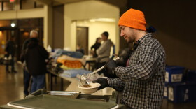 Man ladling soup into bowl.