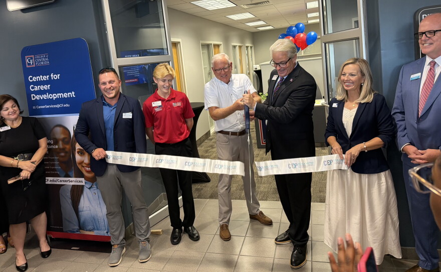 James Henningsen (third from right)President of the College of Central Florida and 2025-2026 Board of Trustees member Rusty Branson cutting the ribbon, officially opening the new Center for Career Development at the CF Ocala Campus Enterprise Center. (Jake Hoffman/WUFT News)