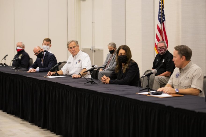 Gov. Greg Abbott and Texas Commission on Environmental Quality executive director Toby Baker and other officials give a press conference. 