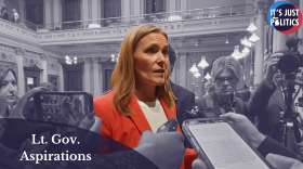 A photo of Winnie Brinks in front of a monochromatic background. In the bottom left corner is a semitransparent semi-circle with the words "Lt. Gov. Aspirations." In the top right corner is the It's Just Politics logo.