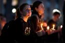 Community members gather during a candlelight vigil for Sgt. Declan Coady, 20, of West Des Moines, Iowa, who died when a drone hit a command center in Port Shuaiba, Kuwait, during the Iran Israel U.S. war, Monday, March 9, 2026, at Drake University in Des Moines, Iowa. (Charlie Neibergall/AP)