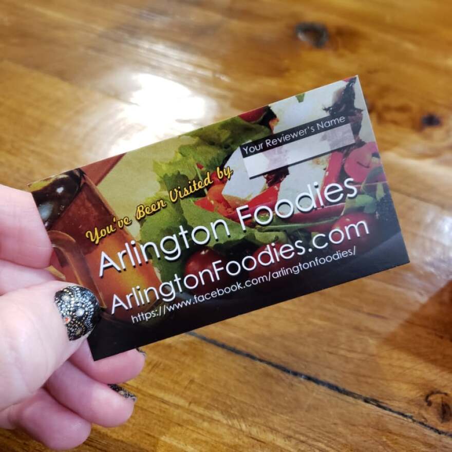 A paper card reads, "You've been visited by Arlington Foodies." 