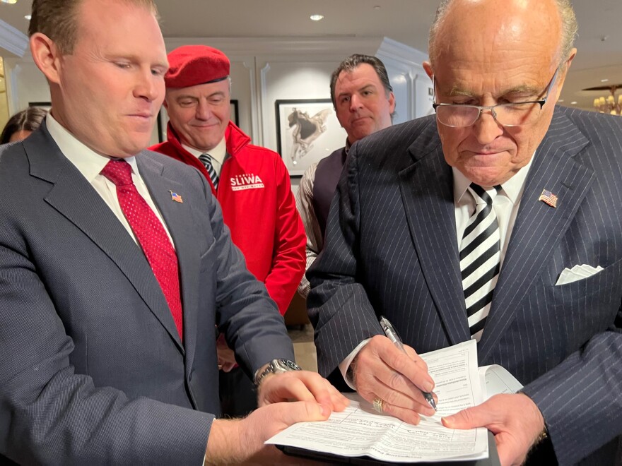  Andrew Giuliani's father, Rudy, signs his petition for governor at the N.Y. GOP convention March 1, 2022.