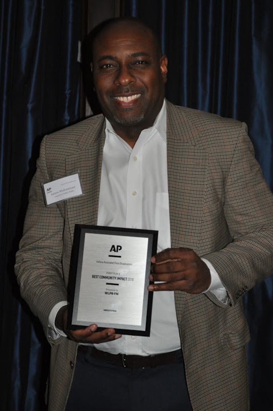 James Muhammad, President and CEO of Lakeshore Public Media, poses with AP's "Best Community Impact" award, which Lakeshore won on Saturday, April 15, 2017.