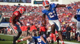 Florida running back Kelvin Taylor (21) leaps over teammate Jake McGee (83) to score a 3-yard touchdown in the second quarter. Taylor rushed for two touchdowns, and 121-yards on 25 carries.