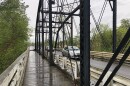  Cars drive across a steel bridge