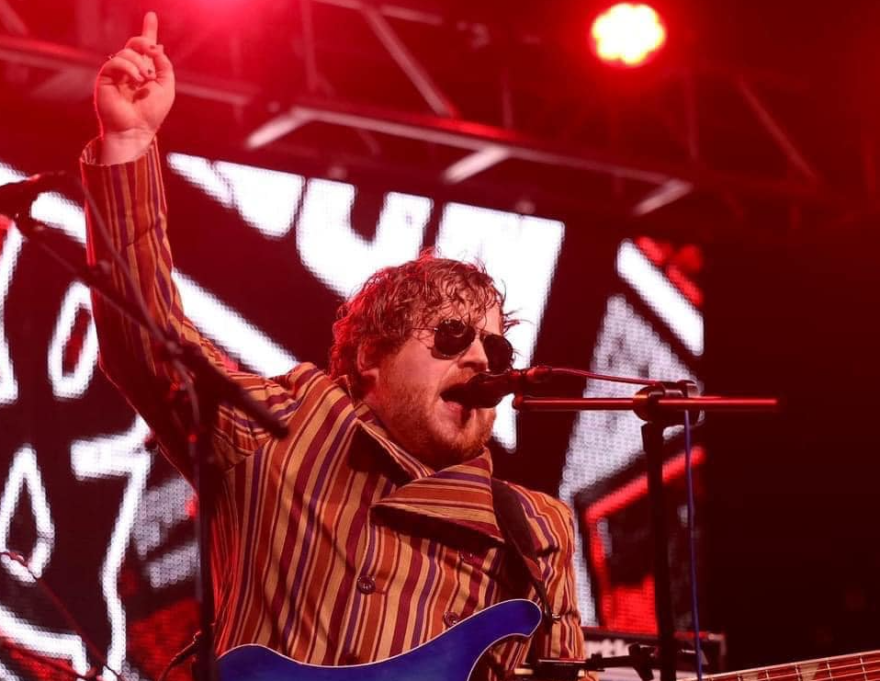 Guy Snowdon plays bass guitar and sings on stage