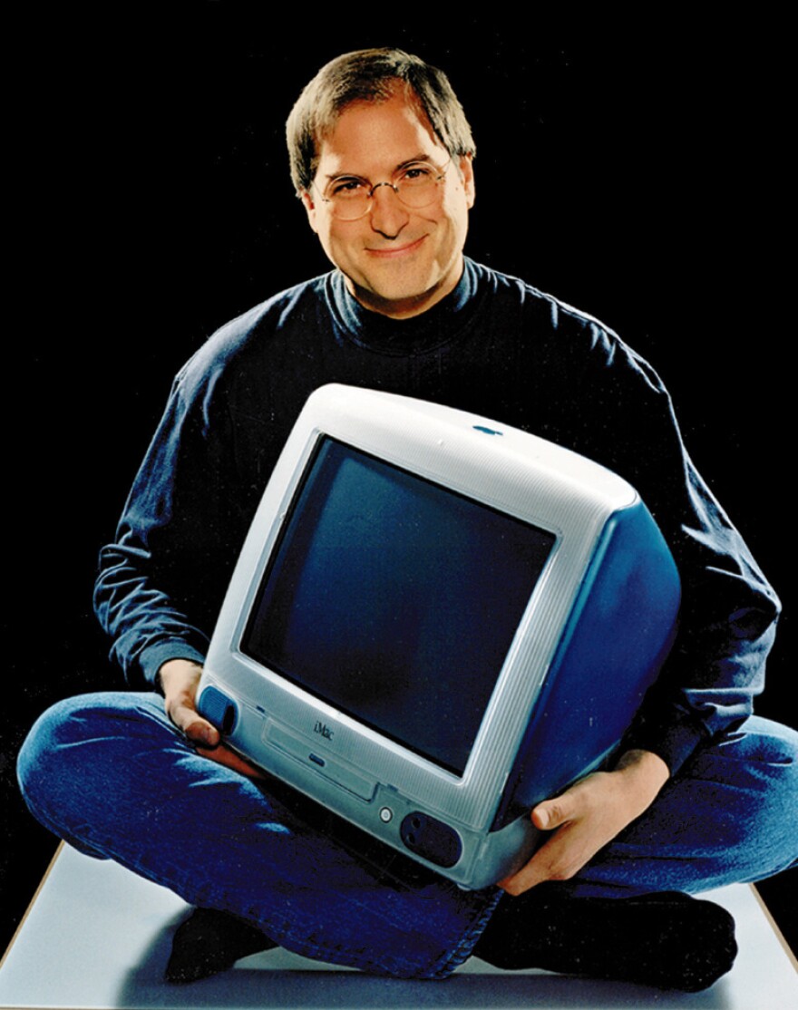 <p>Apple CEO Steve Jobs poses with an iMac in 1998.</p>