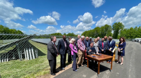 A solar array outside the Bloomfield Board of Education was the backdrop for Gov. Ned Lamont's ceremonial bill signing.