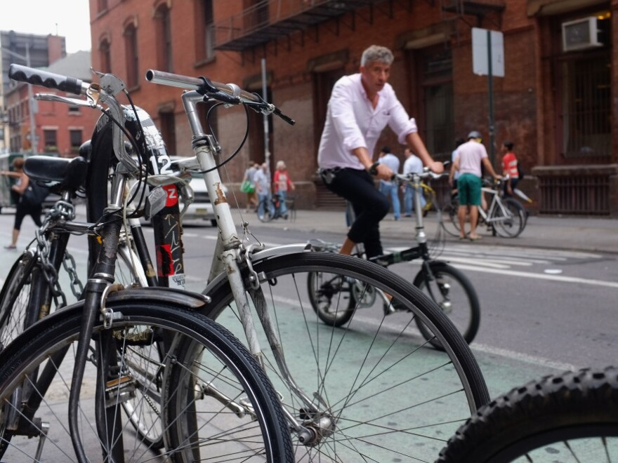 A man rides down a Manhattan street on a bicycle in New York City.