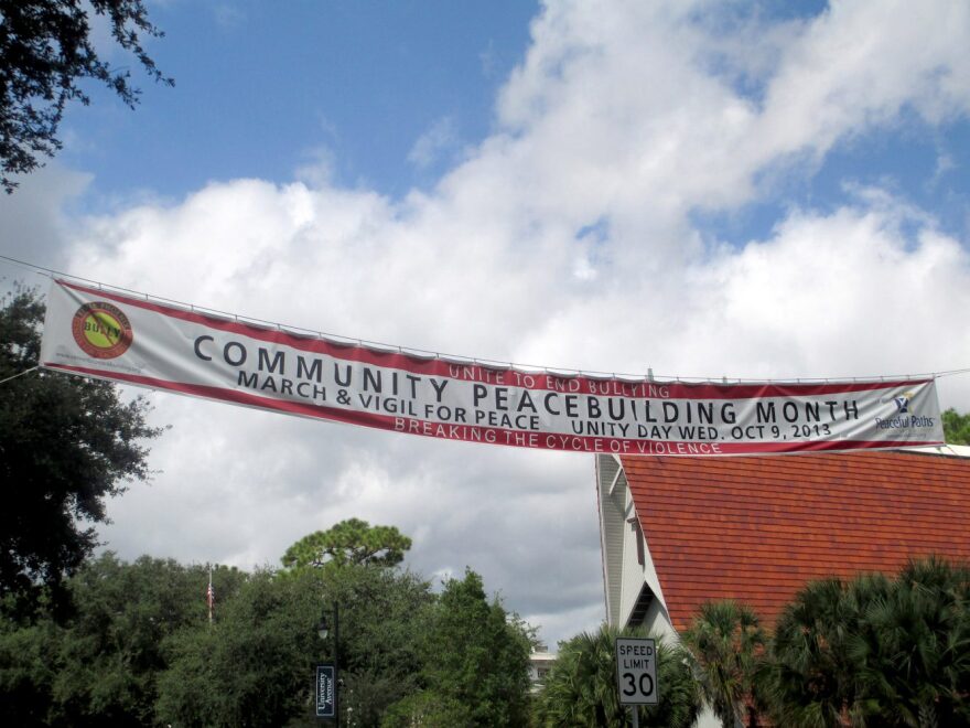 This banner for Peacebuilding Month hangs across University Ave. on Northwest 17th Street