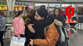Rokhsar Oria receives a hug after arriving in Indianapolis.