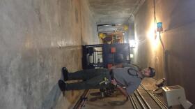 Chena Flood Control project manager Tim Feavel stands inside the "gallery", from where giant gates can be lowered to divert flow of the Chena River on August 15, 2017. (Dan Bross / KUAC)