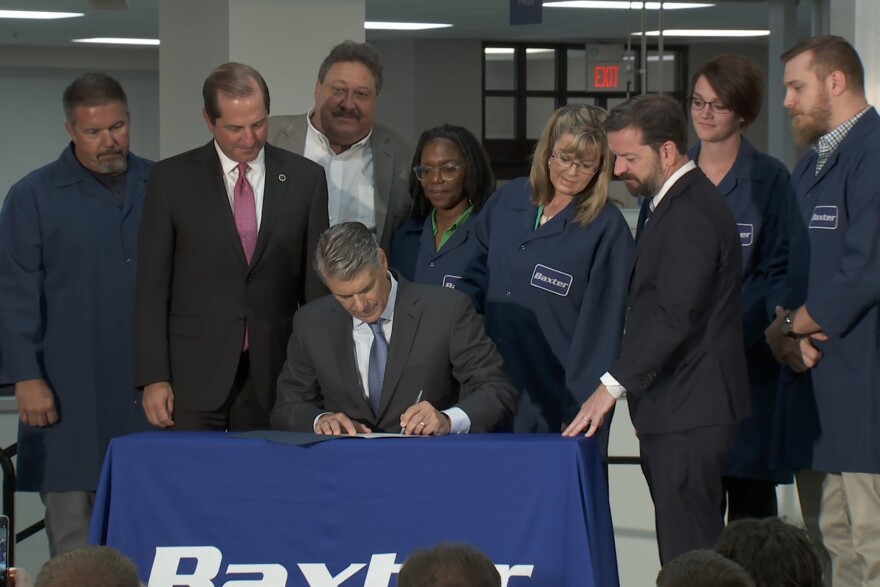 Baxter CEO Joe Almeida signs the Trump administration's "Pledge To America's Workers." U.S. Health and Human Services Secretary Alex Azar traveled to Indiana Friday as part of the signing.