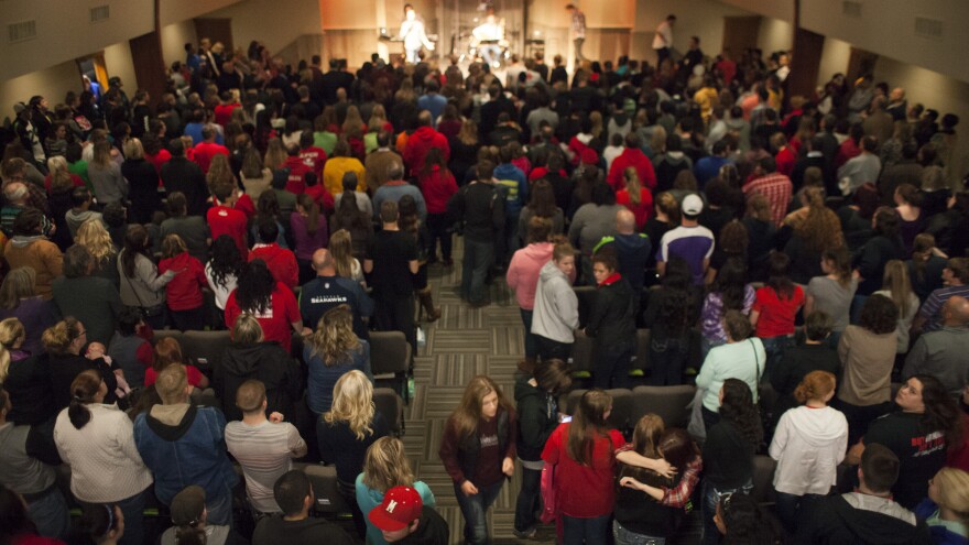 Community members and students from Marysville-Pilchuck High School gather for a vigil at the Grove Church in Marysville, Wash., Friday night. Two students died in the violence, including the gunman. Several more were wounded.