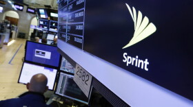 The Sprint logo appears above a trading post on the floor of the New York Stock Exchange, Tuesday, June 27, 2017. Sprint climbed 5.8 percent following a published report suggesting the mobile phone company is in talks with Charter Communications and Comcast Corp. on a deal that could enable the cable operators to buy a stake in Sprint. (Richard Drew/AP)
