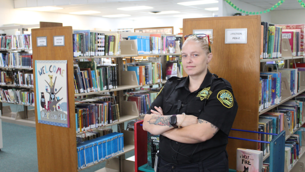 A security guard stands at a public library in Durham, Calif.