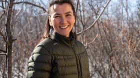 a woman in a green jacket