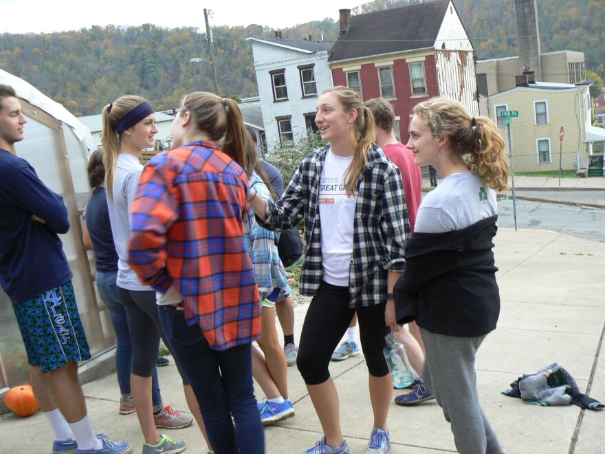 Students from the University of Notre Dame hang out on 14th street in Wheeling, waiting for the next immersive experience.