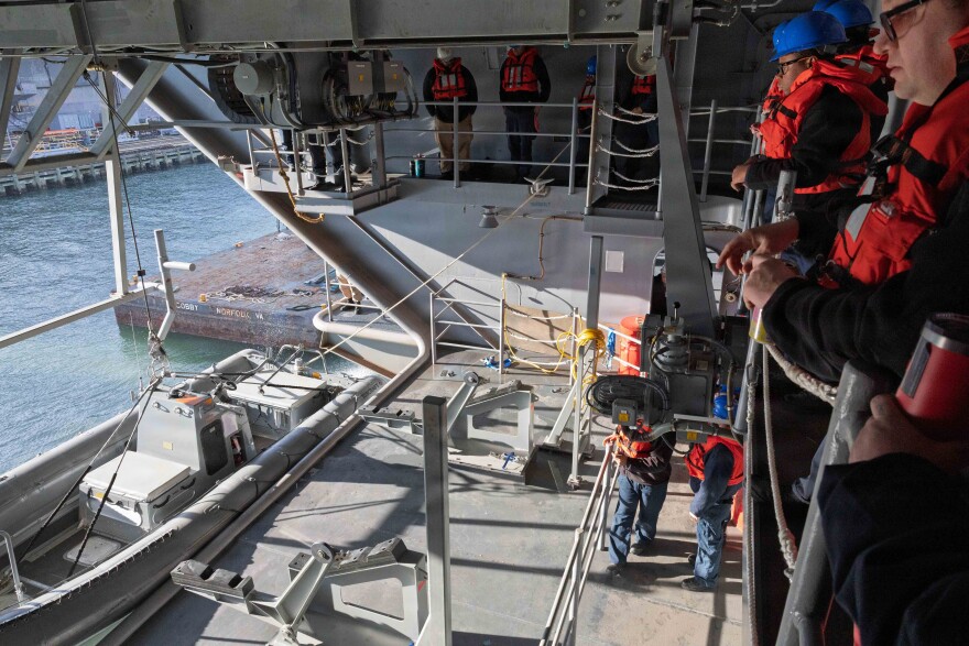 Sailors assigned to Pre-Commissioning Unit of John F. Kennedy lower a rigid-hull inflatable boat.