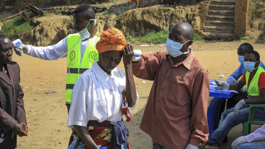 People crossing the border have their temperature taken to check for symptoms of Ebola, near Kasindi, eastern Congo, on Wednesday.