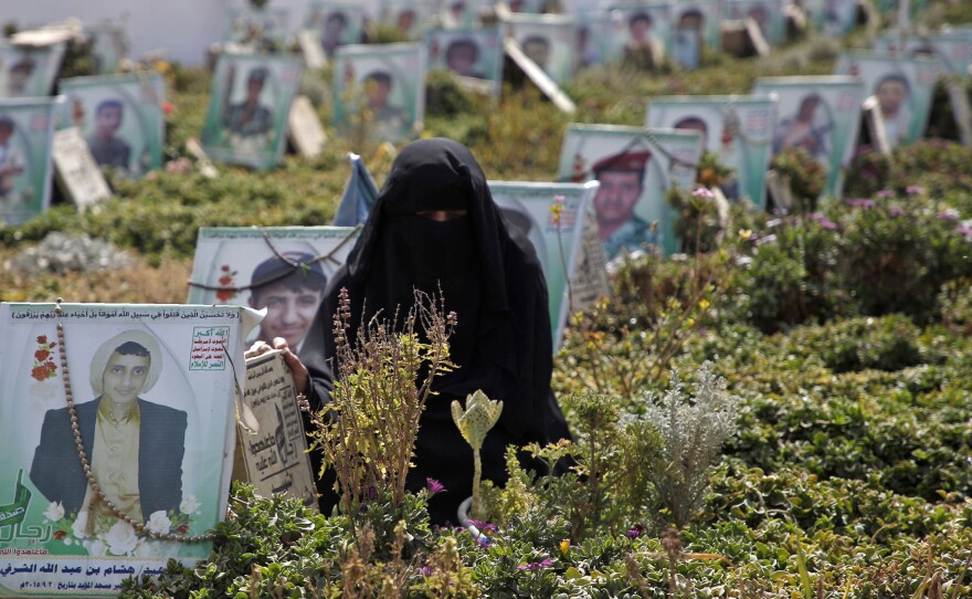 A Yemeni woman visits the grave of a relatives killed while fighting in the country's civil war on 'Martyrs Day' in the capital Sanaa, on Feb. 9.
