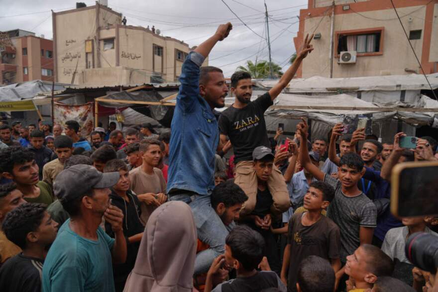 Palestinians celebrate following the announcement that Israel and Hamas have agreed to the first phase of a peace plan to pause the fighting, in Khan Younis, southern Gaza Strip, Thursday, Oct. 9, 2025. Celebrations remain limited, as relief is mixed with mourning and concern for what comes next. (Jehad Alshrafi/AP)