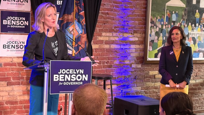 Michigan Secretary of State — and Democratic nominee for governor — Jocelyn Benson speaks at an event the day after the primary election as Governor Gretchen Whitmer looks on.
