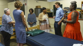 New Haven Mayor Justin Elicker (second from right) talks with Pastor Valerie Washington from Upon This Rock Ministries in a fifty bed shelter that opened in New Haven.