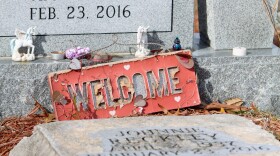 A welcome sign and other trinkets adorn a headstone in Rose Cemetery, a predominately Black cemetery, in Tarpon Springs, Fla., on Jan. 28, 2023. The cemetery is the oldest African American cemetery in Pinellas County. (Rae Riiska/Fresh Take Florida)