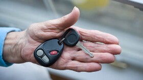 Elderly hand holding car keys