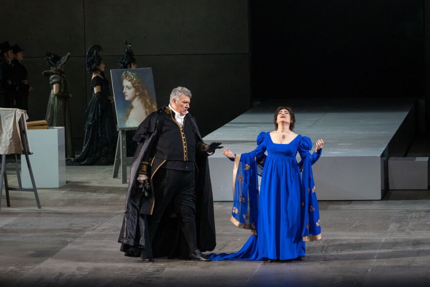 A scene from the NCPA's production of Puccini's Tosca. To the left is baritone Ambrogio Maestri (Scarpia) and to the right is soprano Monica Zanettin (Tosca).