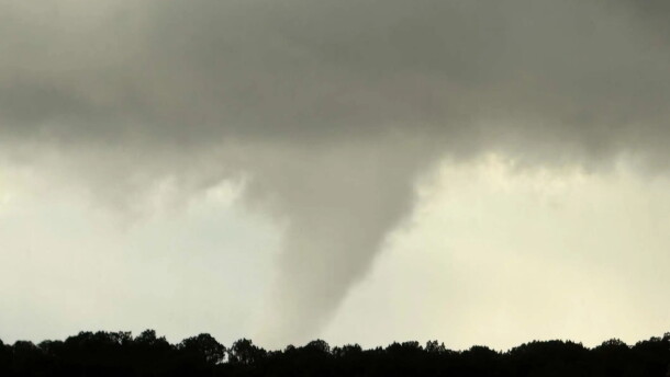 This photo taken by Michelle Vialpando with a smartphone shows a tornado north of Aldea de Santa Fe, N.M., on Saturday, Oct. 24, 2026. The National Weather Service in Albuquerque investigated home damage in Santa Fe over the weekend, ranking the rare tornado as a 'high-end EF1" that produced winds up to 110 mph.