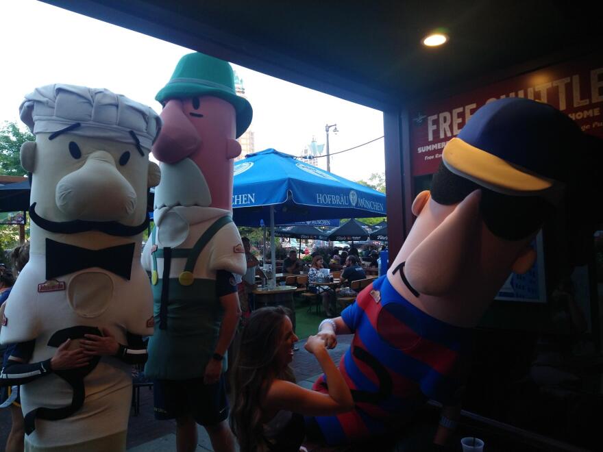 Milwaukee Brewers fans interact with Brat, one of the five popular