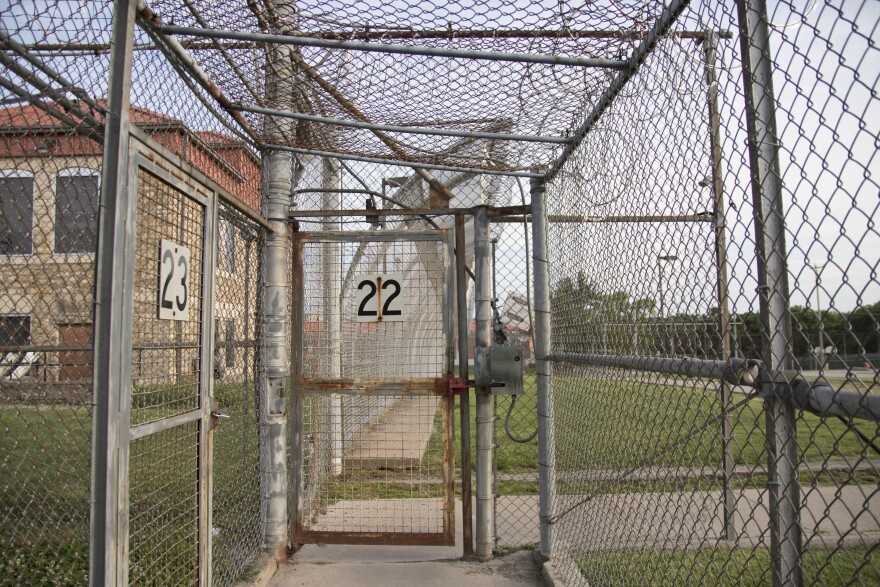 A photo of fences surrounding the outdoor area for inmates at the Topeka Correctional Facility.