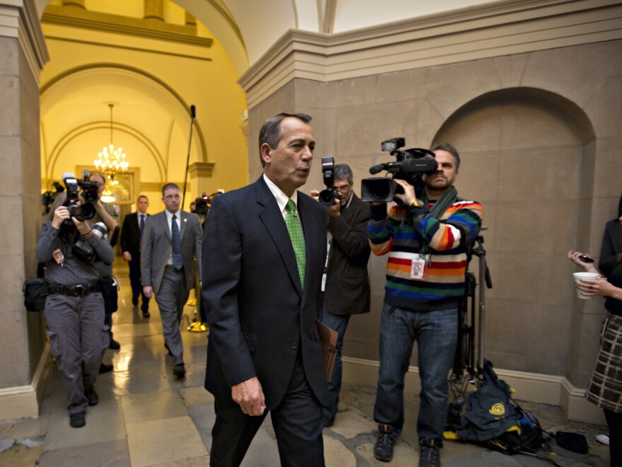 House Speaker John Boehner of Ohio arrives on Capitol Hill on Tuesday as legislation to negate a fiscal cliff of across-the-board tax increases and sweeping spending cuts moves to the GOP-dominated House.