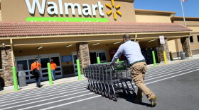 Wal-Mart employee Yurdin Velazquez pushes grocery carts at a Walmart store on Feb. 19, 2015 in Miami. (Joe Raedle/Getty Images)